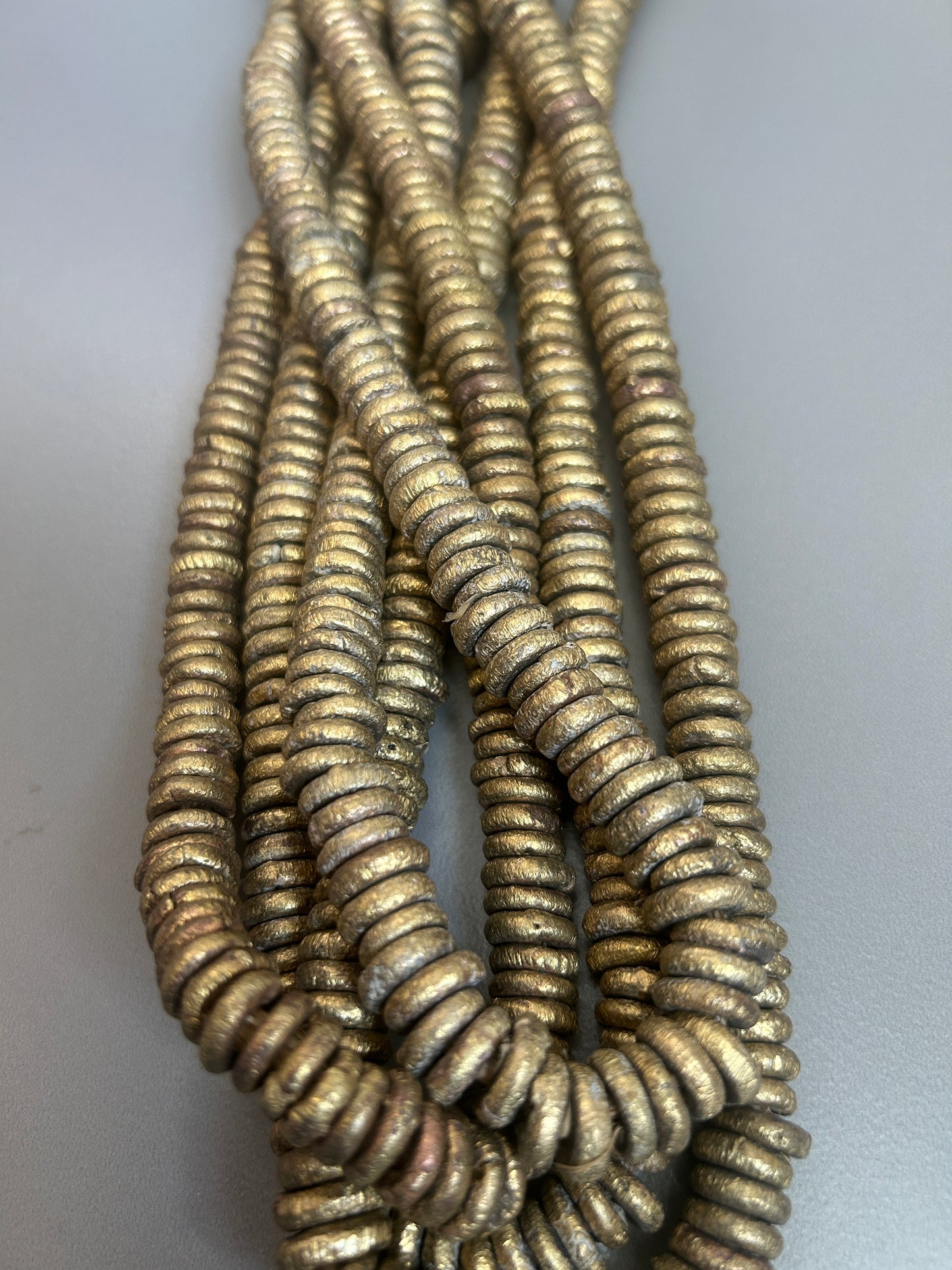 11 mm Ethnic brass rondel (28432)147pcs -strand 19”