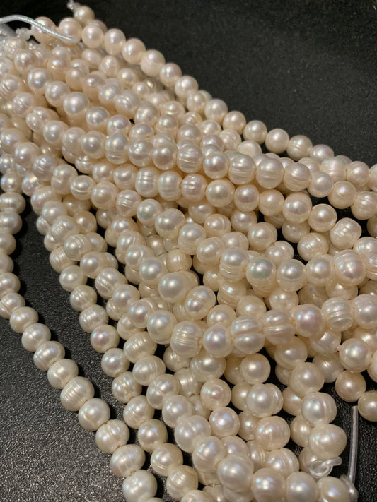 8-10mm wide hole  pearl strand approx 24 pearls per strand. 21143
